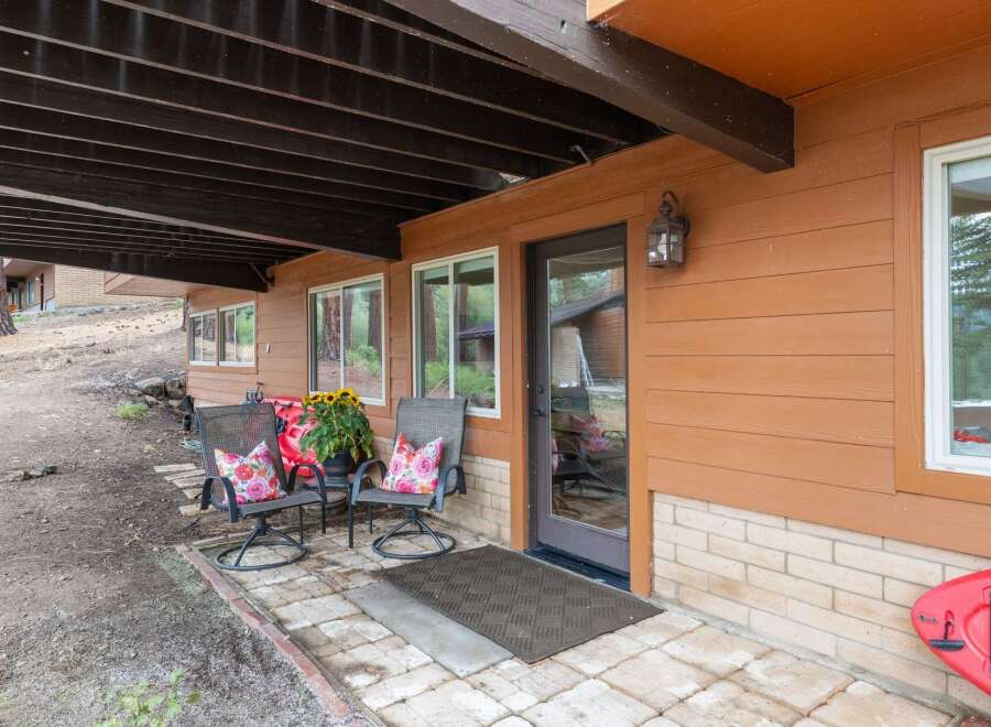 Enjoy outdoor living on this charming covered patio, perfect for relaxing with a view.