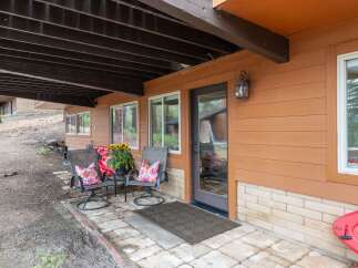 Enjoy outdoor living on this charming covered patio, perfect for relaxing with a view.