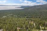 Discover your dream home nestled amidst a lush pine forest with stunning lake views.