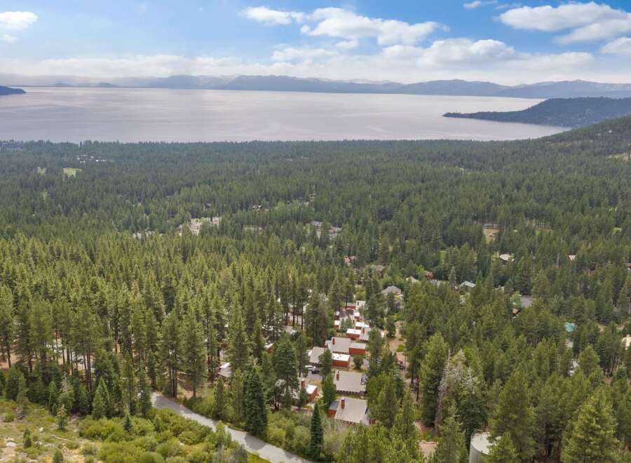 Experience breathtaking lake and mountain views from this stunning property nestled amidst a lush pine forest.