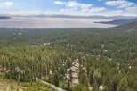 Experience breathtaking lake and mountain views from this stunning property nestled amidst a lush pine forest.