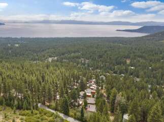 Experience breathtaking lake and mountain views from this stunning property nestled amidst a lush pine forest.
