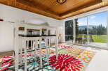 Enjoy breathtaking mountain views from this spacious dining area, featuring a modern white bar table with stools perfect for casual meals.