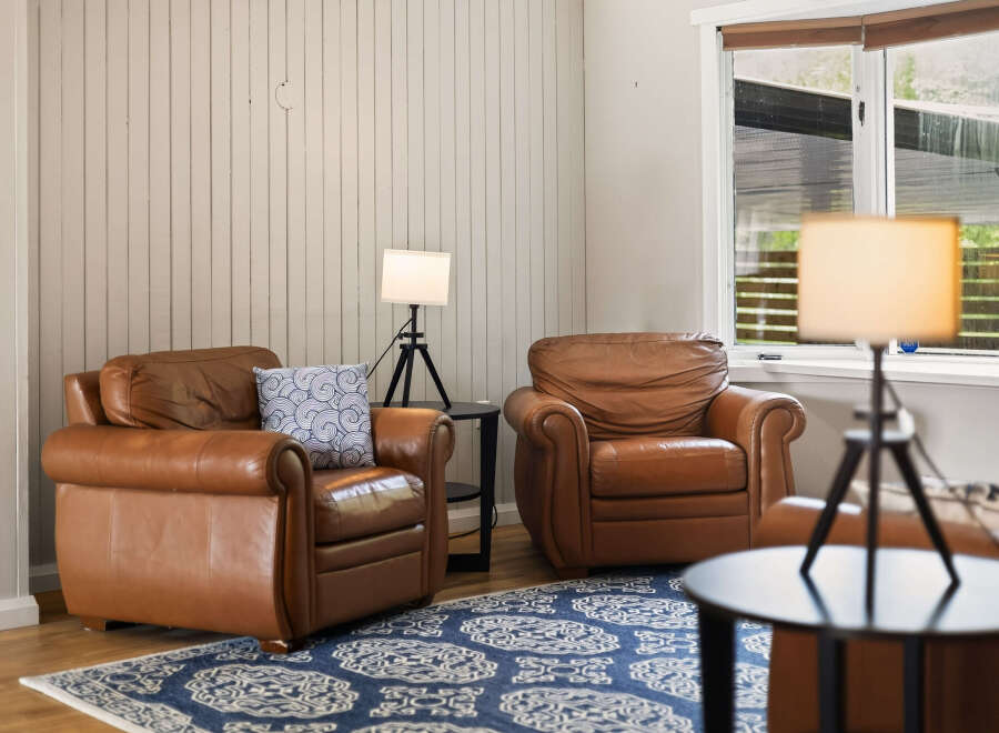 Relax in comfort in this inviting living space, featuring two plush leather armchairs perfect for unwinding.