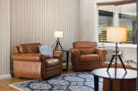 Relax in comfort in this inviting living space, featuring two plush leather armchairs perfect for unwinding.