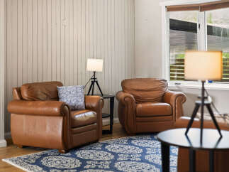 Relax in comfort in this inviting living space, featuring two plush leather armchairs perfect for unwinding.