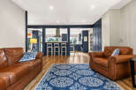 Experience seamless living in this beautifully appointed home, featuring a spacious open-concept layout that connects the living area to a modern kitchen.