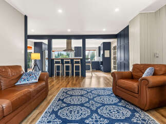 Experience seamless living in this beautifully appointed home, featuring a spacious open-concept layout that connects the living area to a modern kitchen.