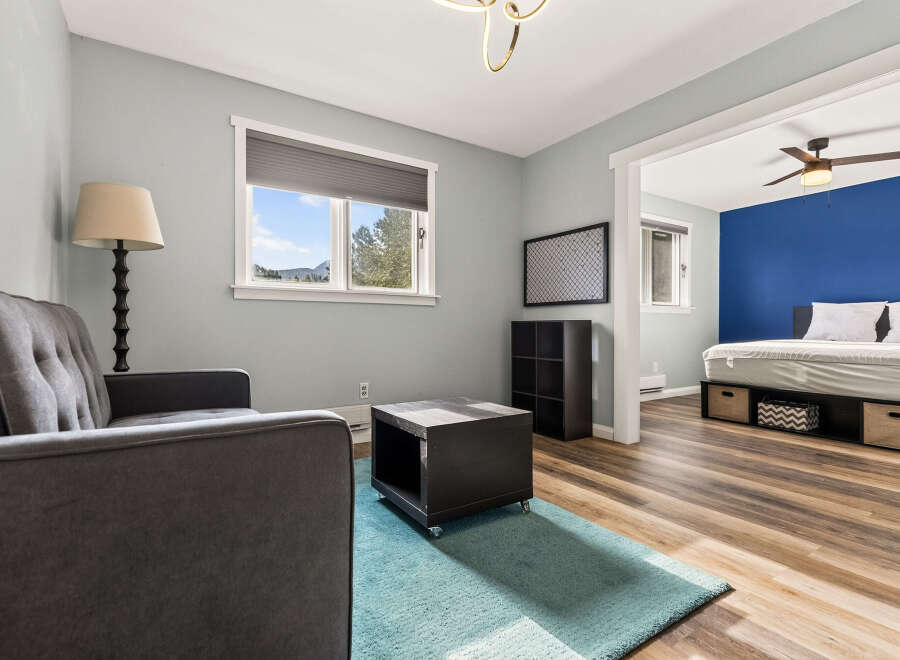 Discover comfort and style in this inviting living space, featuring a plush grey sofa and a modern coffee table.