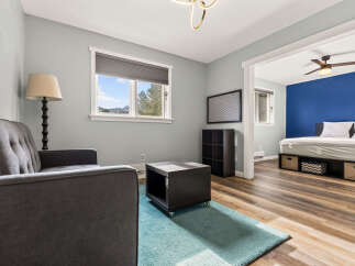 Discover comfort and style in this inviting living space, featuring a plush grey sofa and a modern coffee table.