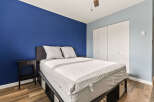 Experience comfort and style in this inviting bedroom, featuring a plush bed with a textured mattress topper and two supportive pillows.