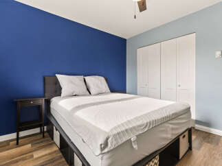 Experience comfort and style in this inviting bedroom, featuring a plush bed with a textured mattress topper and two supportive pillows.
