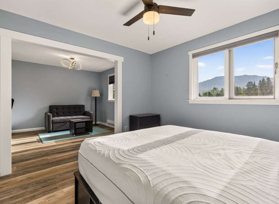 Experience comfort and style in this inviting bedroom, featuring a plush mattress and a serene blue-gray color palette.