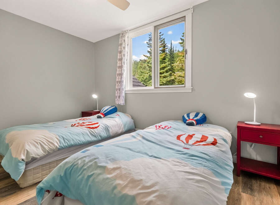 This charming bedroom features two twin beds, perfect for siblings or guests.