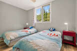 This charming bedroom features two twin beds, perfect for siblings or guests.