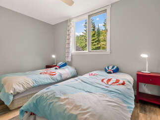 This charming bedroom features two twin beds, perfect for siblings or guests.