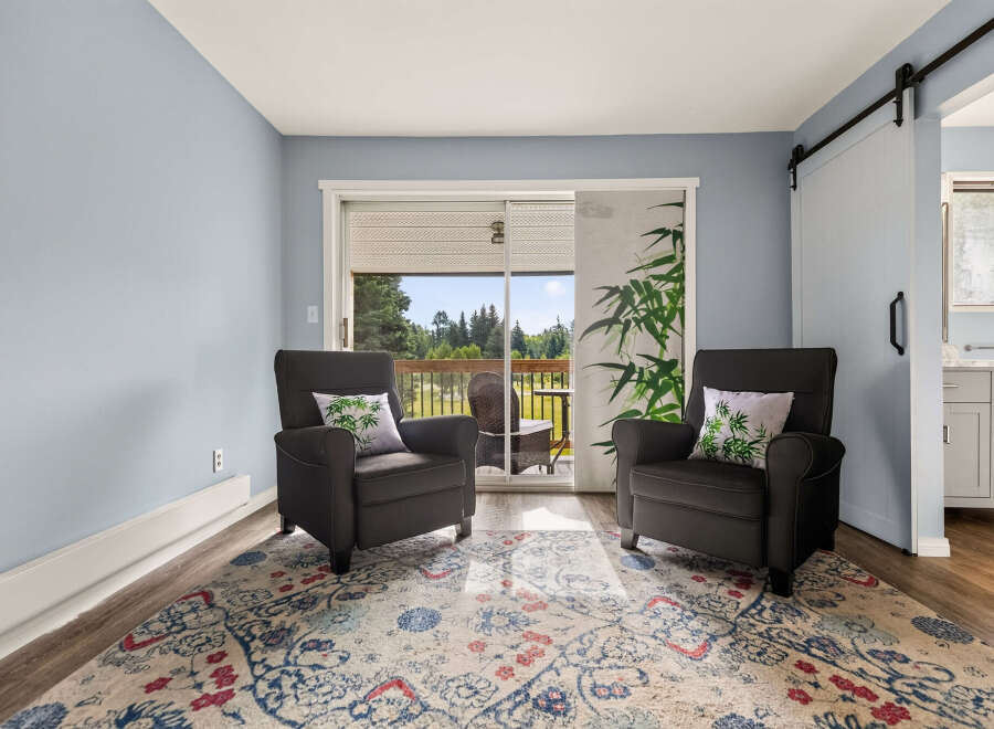 Relax in comfort in this inviting living space, featuring two plush armchairs perfect for unwinding.