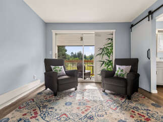 Relax in comfort in this inviting living space, featuring two plush armchairs perfect for unwinding.