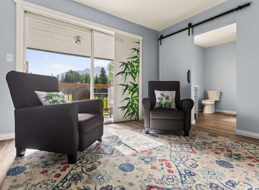Relax in comfort in this inviting living space, featuring two plush armchairs perfect for unwinding.