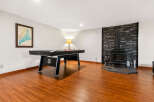 Enjoy endless entertainment in this finished basement featuring a regulation-size pool table perfect for game nights.