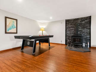 Enjoy endless entertainment in this finished basement featuring a regulation-size pool table perfect for game nights.