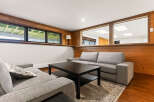 This inviting living space features a cozy sectional sofa and a dark wood coffee table, perfect for relaxing evenings.