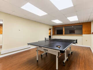 Enjoy endless fun in this spacious recreational room, perfect for hosting game nights or unwinding after a long day.