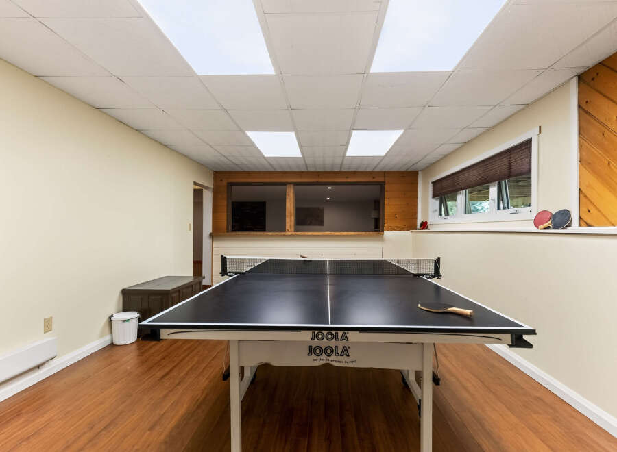 Enjoy endless fun in this recreational room featuring a professional JOOLA ping pong table.