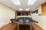 Enjoy endless fun in this recreational room featuring a professional JOOLA ping pong table.