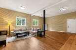 This spacious living area features a comfortable sectional sofa, perfect for relaxing or entertaining guests.