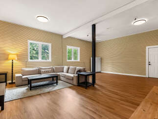 This spacious living area features a comfortable sectional sofa, perfect for relaxing or entertaining guests.