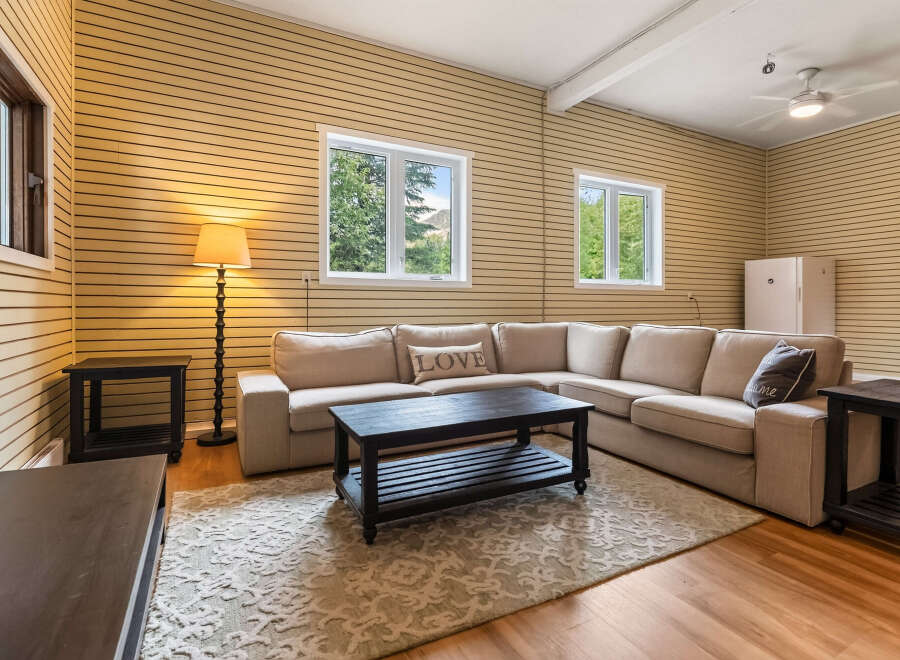 Step into this inviting living room, featuring a spacious sectional sofa perfect for gatherings and a stylish dark wood coffee table.