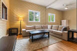 Step into this inviting living room, featuring a spacious sectional sofa perfect for gatherings and a stylish dark wood coffee table.