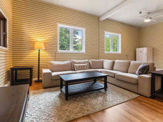 Step into this inviting living room, featuring a spacious sectional sofa perfect for gatherings and a stylish dark wood coffee table.