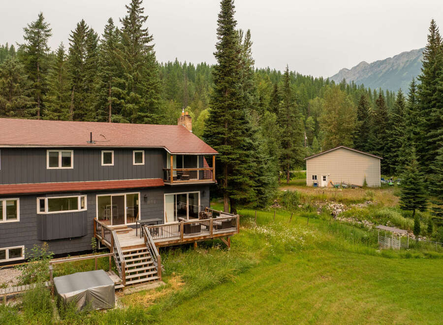 Nestled amidst a lush forest and rolling hills, this expansive property offers a serene retreat.