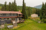 Nestled amidst a lush forest and rolling hills, this expansive property offers a serene retreat.