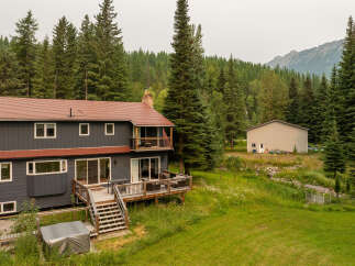 Nestled amidst a lush forest and rolling hills, this expansive property offers a serene retreat.