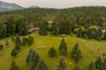 Nestled amidst a lush forest and rolling green hills, this property offers a serene mountain retreat.