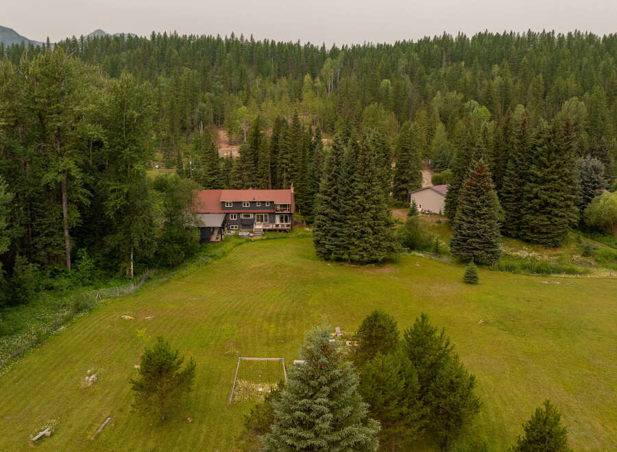 Nestled amidst a lush, forested landscape, this expansive property offers a serene retreat.