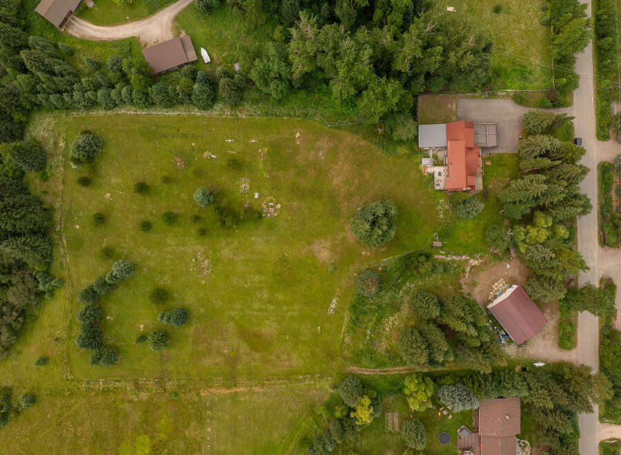 Discover this expansive property featuring a large, open grassy field perfect for outdoor activities or potential development.