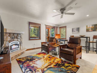 Cozy living room featuring a stone fireplace and comfortable leather recliners, perfect for relaxing evenings.