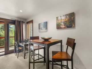 Enjoy a meal or work from home in this charming dining area, featuring a stylish high-top table and chairs.