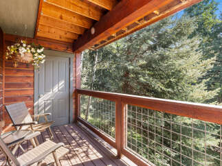 Enjoy the serene mountain views from this charming covered porch, perfect for morning coffee or evening relaxation.