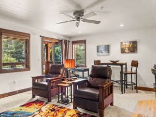 Relax in comfort in this inviting living space, featuring plush leather recliners perfect for unwinding.