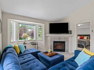 Cozy living room featuring a plush blue sectional sofa and a gas fireplace, perfect for relaxing evenings.