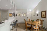 This inviting dining area features a round wooden table with four chairs, perfect for intimate gatherings.