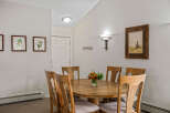 Gather around the elegant wooden dining table, perfect for intimate meals or lively gatherings.