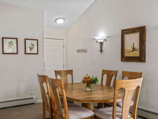Gather around the elegant wooden dining table, perfect for intimate meals or lively gatherings.