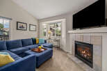 Cozy up by the gas fireplace in this inviting living room, featuring a spacious sectional sofa perfect for family gatherings.