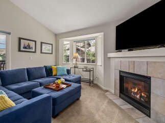 Cozy up by the gas fireplace in this inviting living room, featuring a spacious sectional sofa perfect for family gatherings.